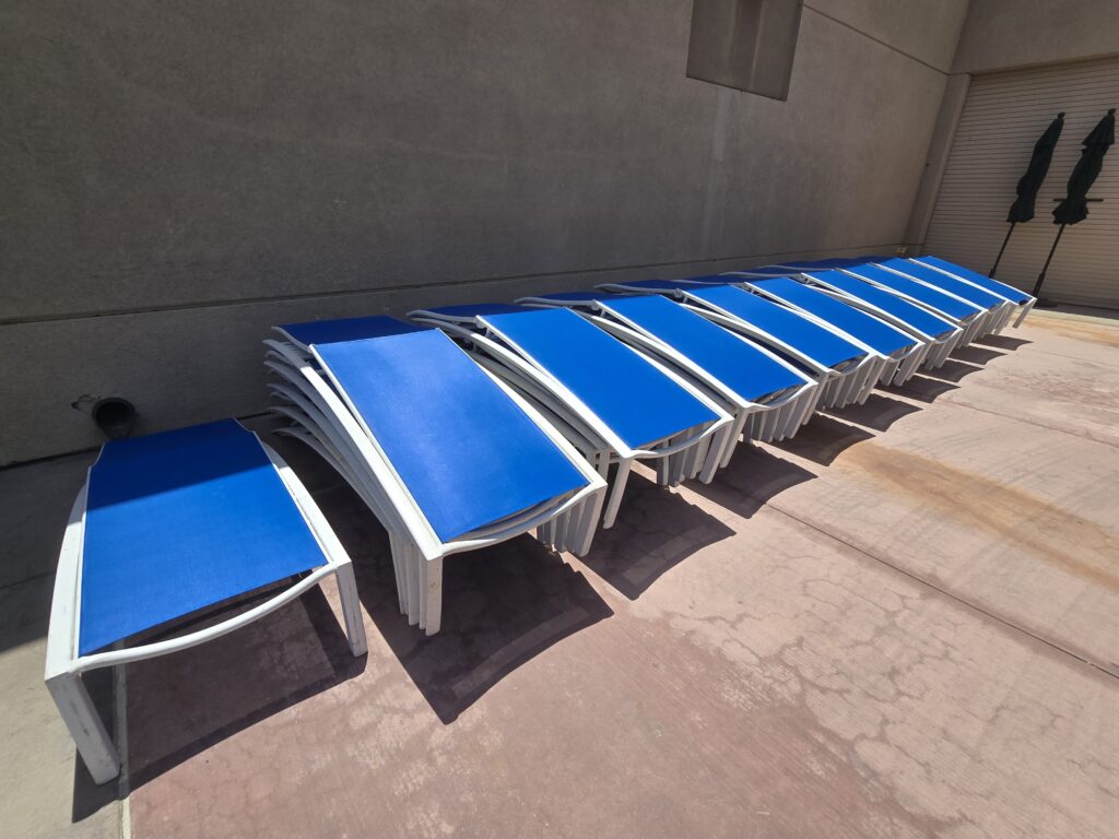 Finished slings stacked Finished pool chaises with new Pacific blue sling fabric